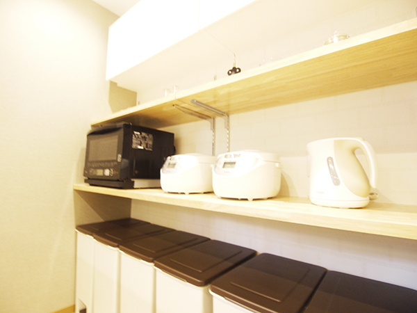 There is a microwave oven, rice cooker, T-fal and toaster.