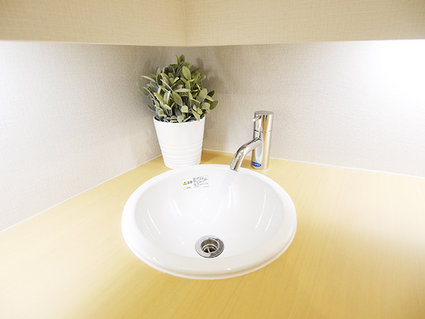 The powder room has a small washbasin and is convenient