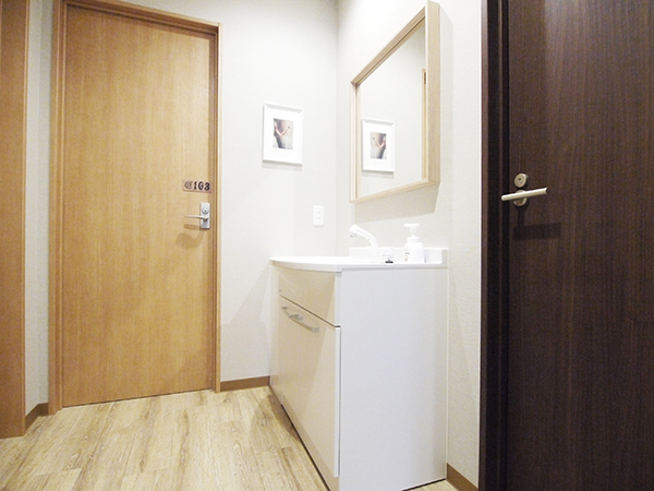 It is a washbasin in front of room 103 on the first floor. The right door is the shower room